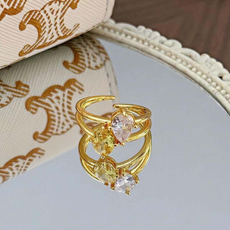 Dazzling Toi et Moi Open Ring featuring a Pear-cut Clear Zircon and Oval Orange Cubic Zirconia in 14K Gold Plated Band