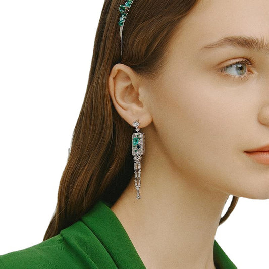 Elegant long tassel drop earrings with 18K white gold plating. Sleek vertical silver-tone linear design