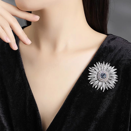 Elegant wheat ear brooch featuring light blue and white cubic zirconia stones in an 18K white gold plated setting
