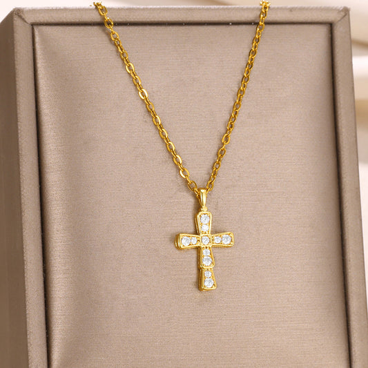 Elegant gold cross pendant necklace featuring brilliant zircon accents in a classic religious starburst design