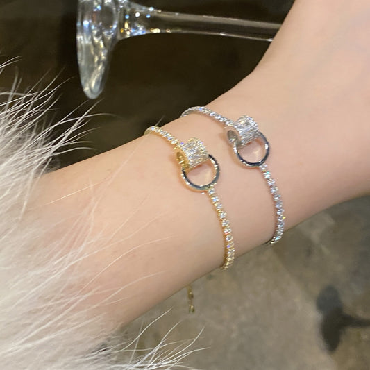 Chic double-layered bracelet featuring cubic zirconia charms, available in gold and silver plated finishes