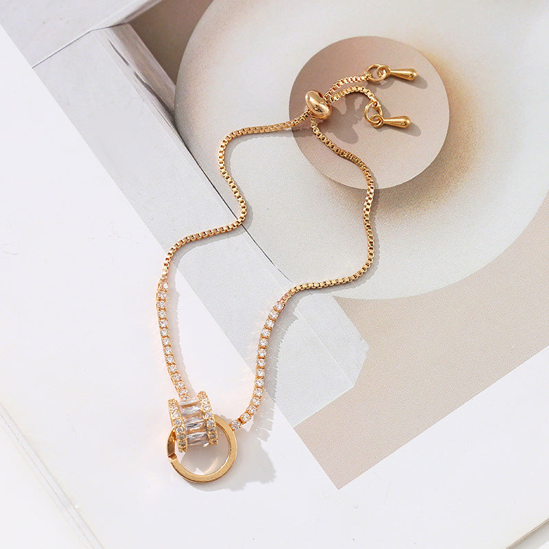 Chic double-layered bracelet featuring cubic zirconia charms, available in gold and silver plated finishes