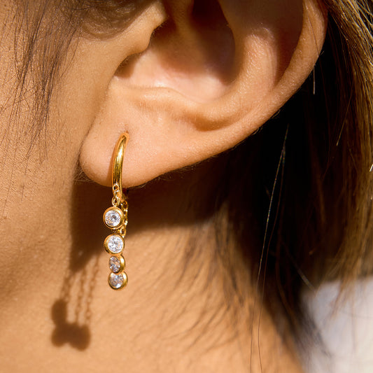 Gold stainless steel chunky hoop earrings featuring three rows of sparkling clear zirconia stones