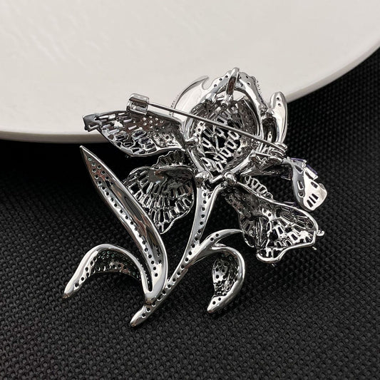 Elegant lily flower brooch with gradient-colored cubic zirconia petals and a sparkling crystal center