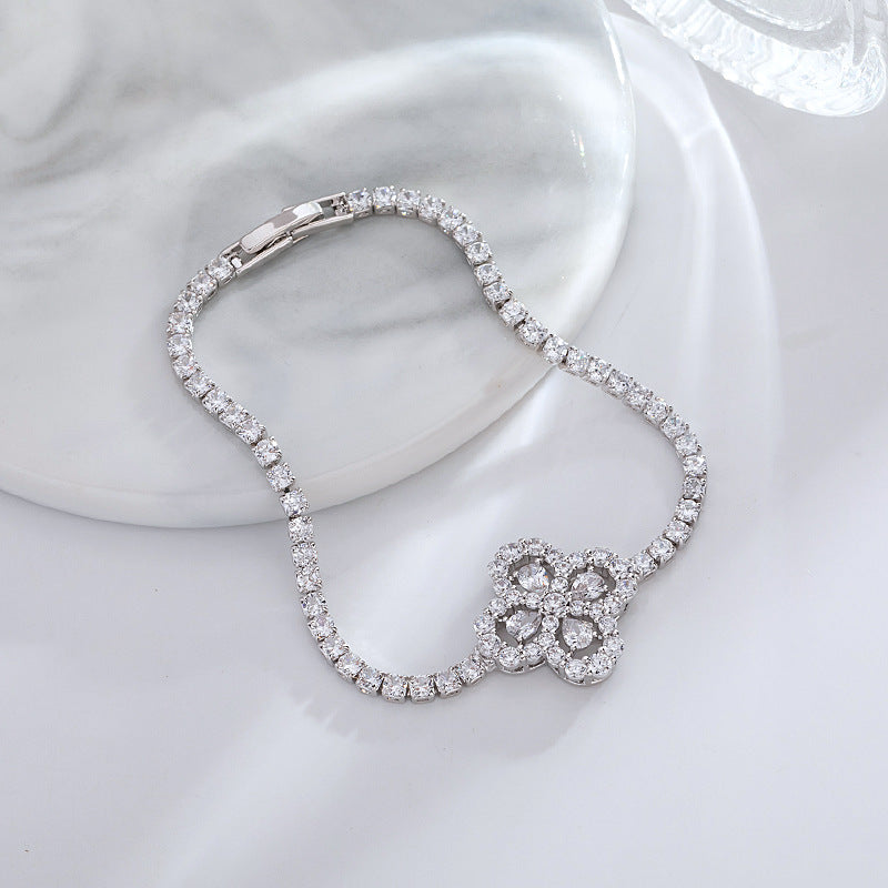 S925 sterling silver tennis bracelet with a four-leaf clover halo charm featuring sparkling cubic zirconia
