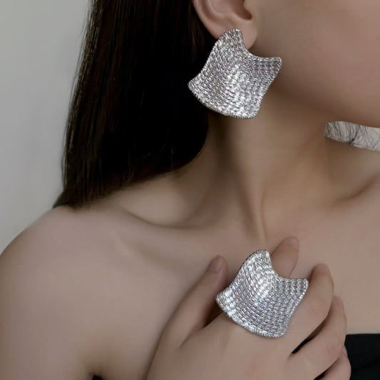 Silver huggie hoop earrings with a continuous row of sparkling clear zirconia stones in a pave setting