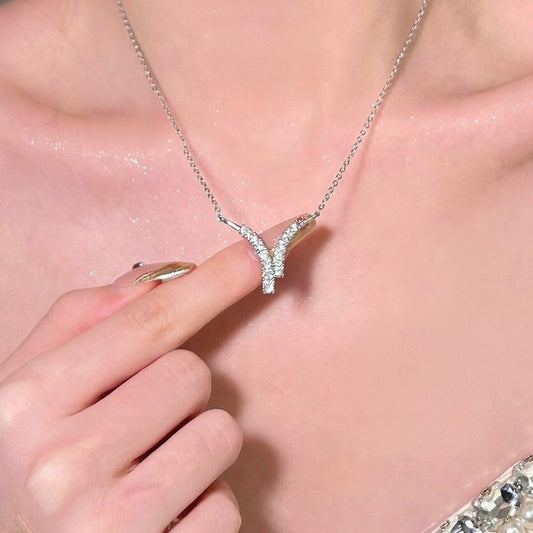 Elegant V-shaped horn pendant necklace featuring sparkling cubic zirconia stones in a minimalist design