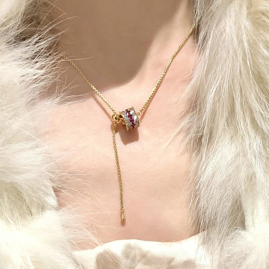 18K gold plated cylinder pendant necklace encrusted with shimmering cubic zirconia stones for a modern look