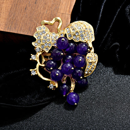 Elegant 18K gold plated grape brooch featuring mint green and purple cubic zirconia stones in a fruit-themed design