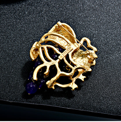 Elegant 18K gold plated grape brooch featuring mint green and purple cubic zirconia stones in a fruit-themed design