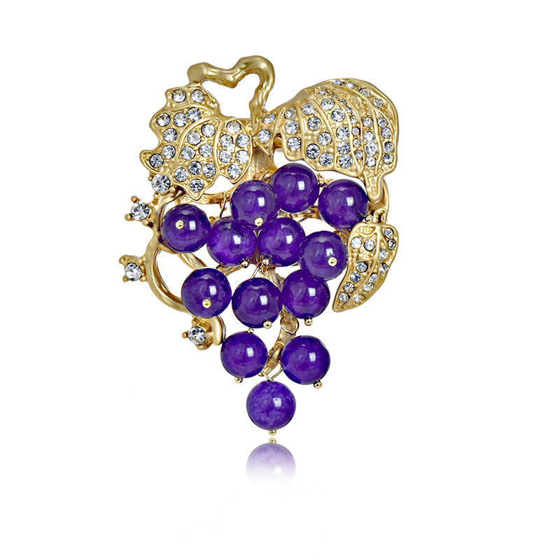 Elegant 18K gold plated grape brooch featuring mint green and purple cubic zirconia stones in a fruit-themed design
