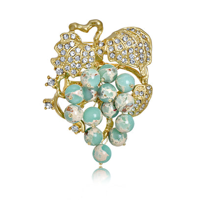Elegant 18K gold plated grape brooch featuring mint green and purple cubic zirconia stones in a fruit-themed design