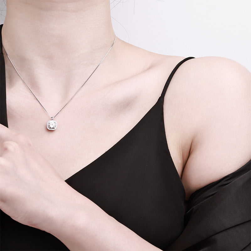 Elegant S925 sterling silver necklace featuring a 1ct round moissanite centerpiece surrounded by a sparkling square halo of accent stones