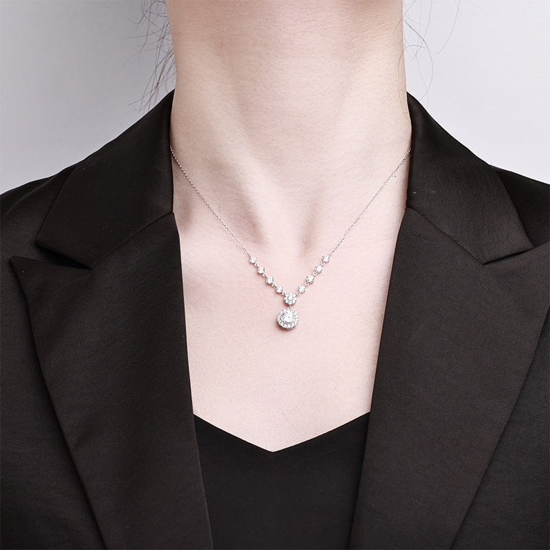 Sparkling S925 sterling silver necklace featuring a 1ct round moissanite centerpiece with a brilliant halo of accent stones