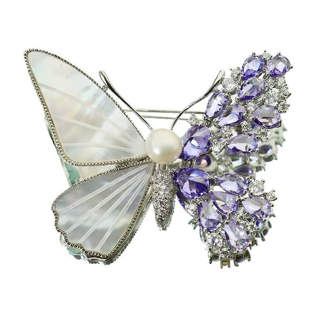 Unique asymmetric butterfly brooch with white mother-of-pearl, purple cubic zirconia clusters, and a central pearl