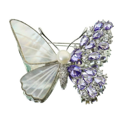 Unique asymmetric butterfly brooch with white mother-of-pearl, purple cubic zirconia clusters, and a central pearl