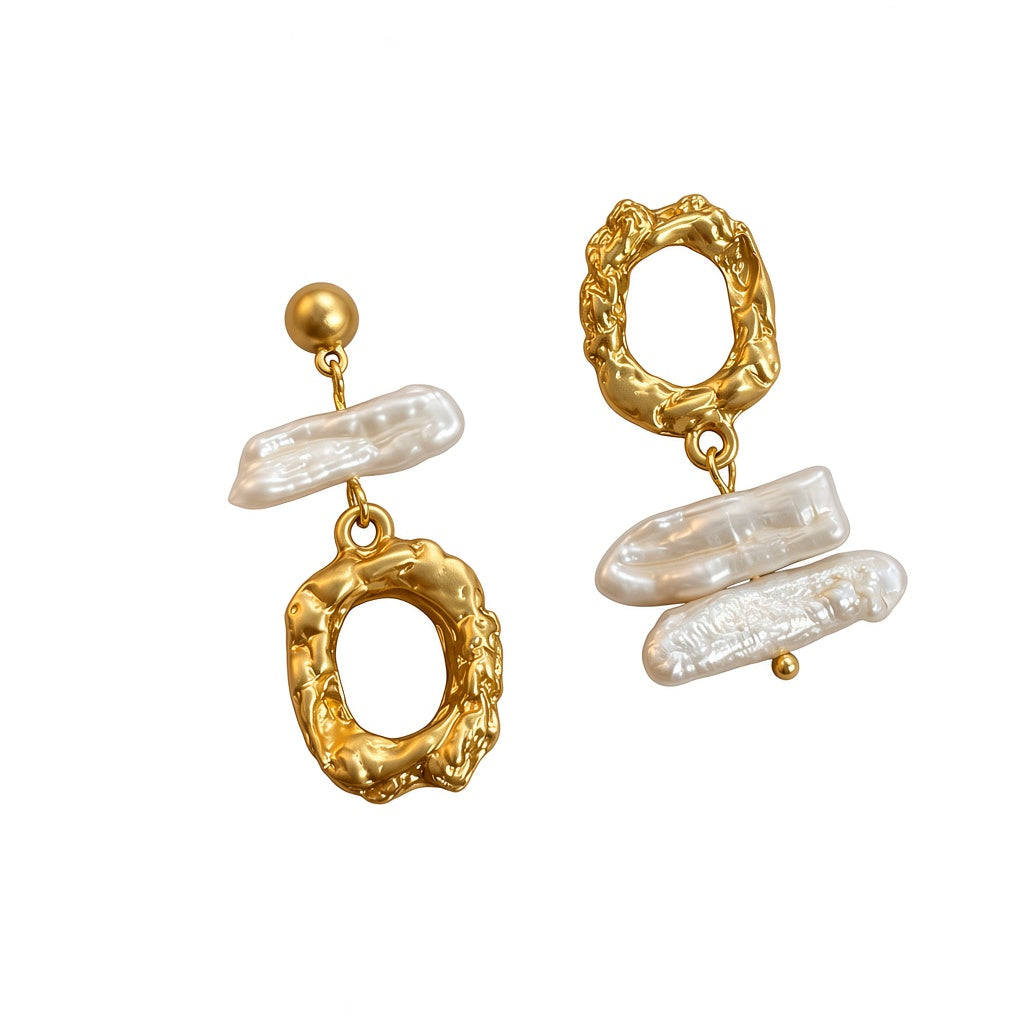 Asymmetric natural baroque freshwater pearl statement drop earrings with textured organic gold and silver hoops.