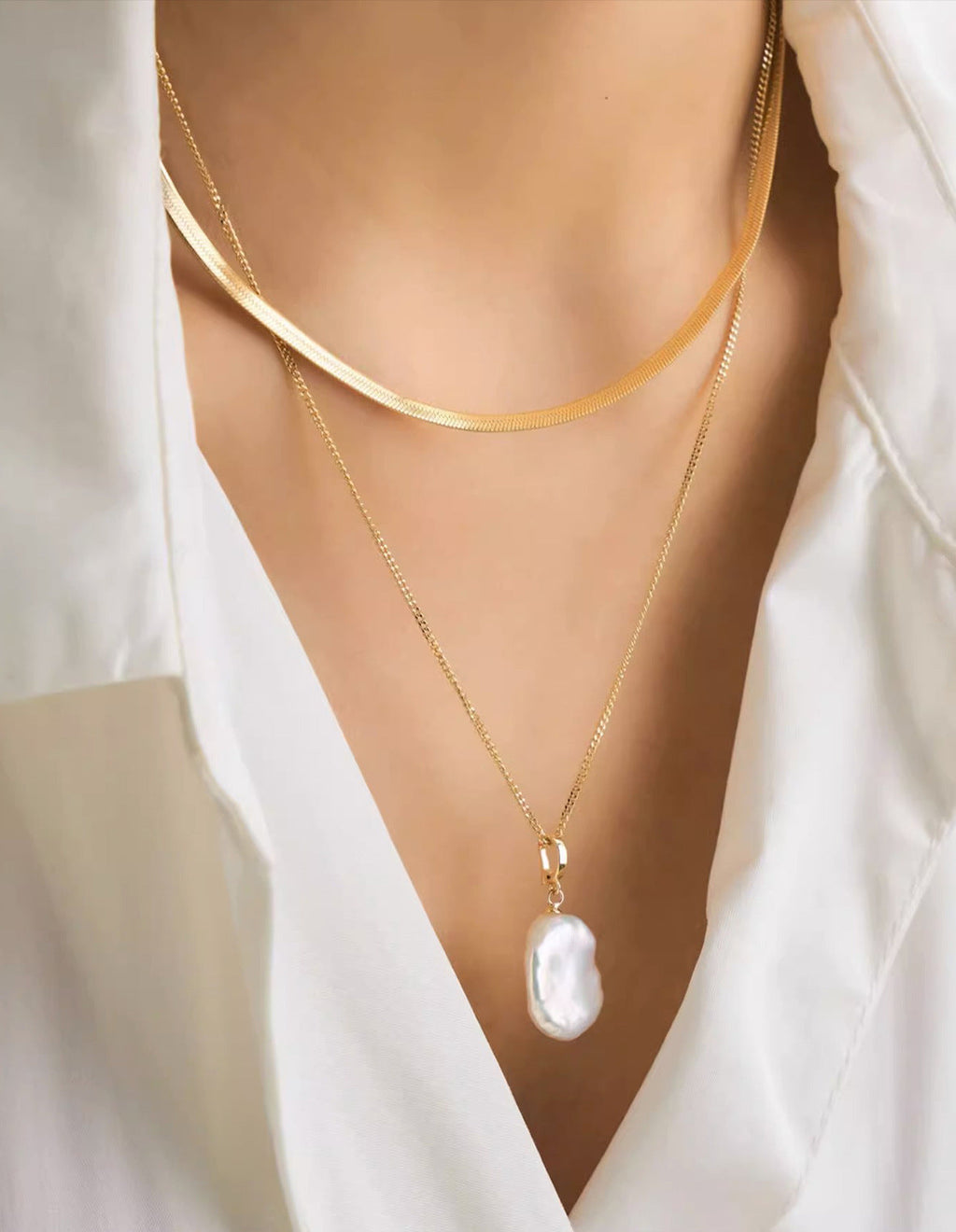 Natural baroque pearl pendant cable chain and flat herringbone chain layered necklace in gold plated titanium steel jewelry.