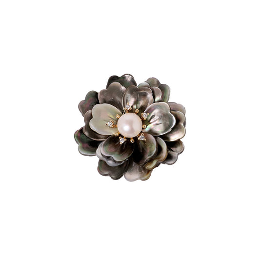 Elegant camellia brooch featuring black mother-of-pearl petals, a central white pearl, and shimmering zirconia accents