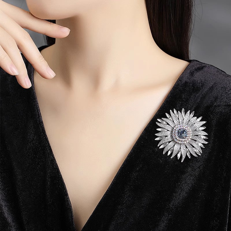 Elegant wheat ear brooch featuring light blue and white cubic zirconia stones in an 18K white gold plated setting