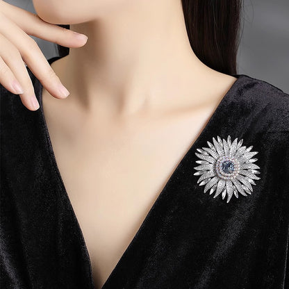 Elegant wheat ear brooch featuring light blue and white cubic zirconia stones in an 18K white gold plated setting