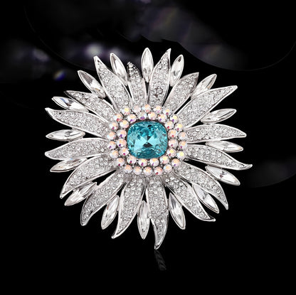 Elegant wheat ear brooch featuring light blue and white cubic zirconia stones in an 18K white gold plated setting