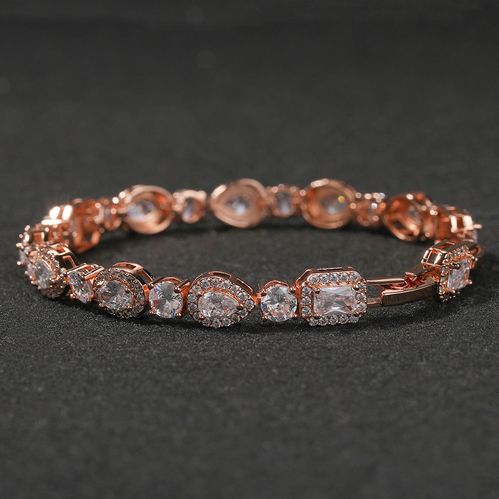 Elegant bypass wrap bracelet with sparkling zirconia halo charms, available in gold, silver, and rose gold