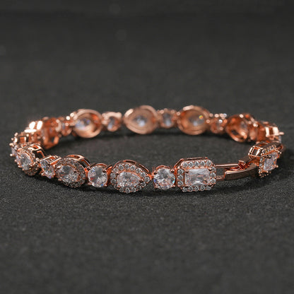 Elegant bypass wrap bracelet with sparkling zirconia halo charms, available in gold, silver, and rose gold