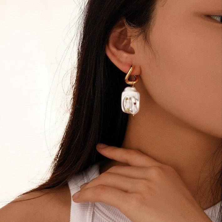 Natural Stainless steel jewelry baroque pearl huggie drop earrings inlaid with gold starburst cz crystal and ruby red stone accents.