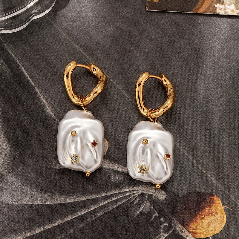 Natural Stainless steel jewelry baroque pearl huggie drop earrings inlaid with gold starburst cz crystal and ruby red stone accents.