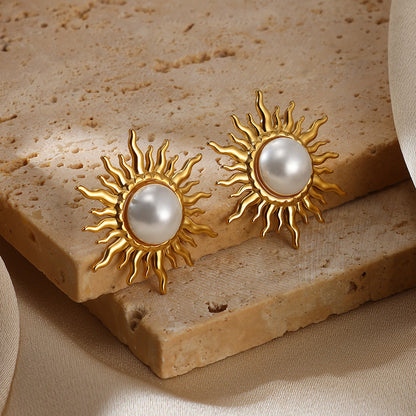 Paired vintage-style gold sunburst stud earrings featuring a central lustrous white pearl