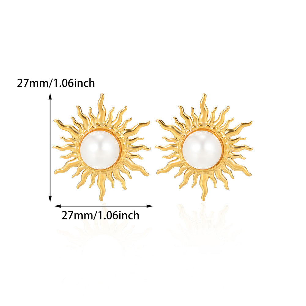 Paired vintage-style gold sunburst stud earrings featuring a central lustrous white pearl
