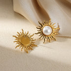 Paired vintage-style gold sunburst stud earrings featuring a central lustrous white pearl