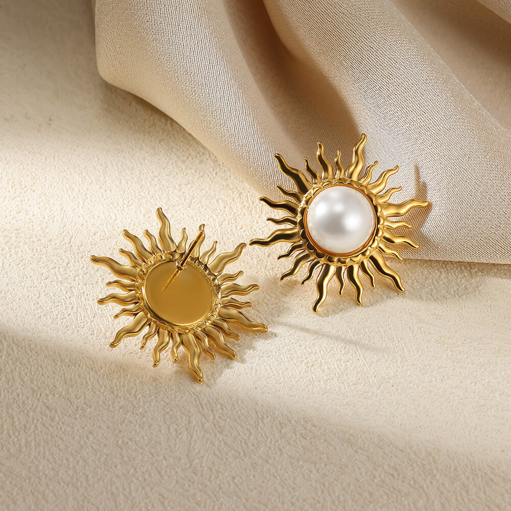 Paired vintage-style gold sunburst stud earrings featuring a central lustrous white pearl