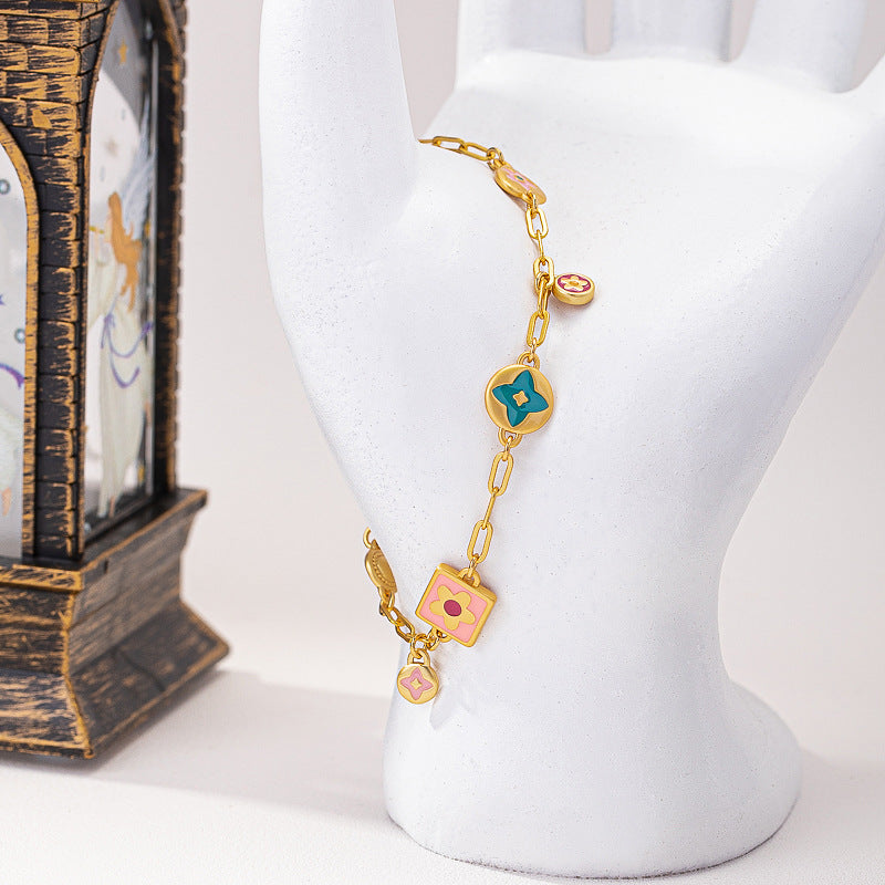 Colorful  Stainless steel jewelry enamel double-sided dopamine bracelet with pastel flower and heart charms on a gold paperclip chain.