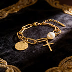 Cross charm pearl bead and engraved quote disc paperclip chain stainless steel jewelry bracelet in waterproof 18k gold plated finish.