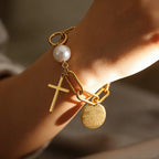 Cross charm pearl bead and engraved quote disc paperclip chain stainless steel jewelry bracelet in waterproof 18k gold plated finish.