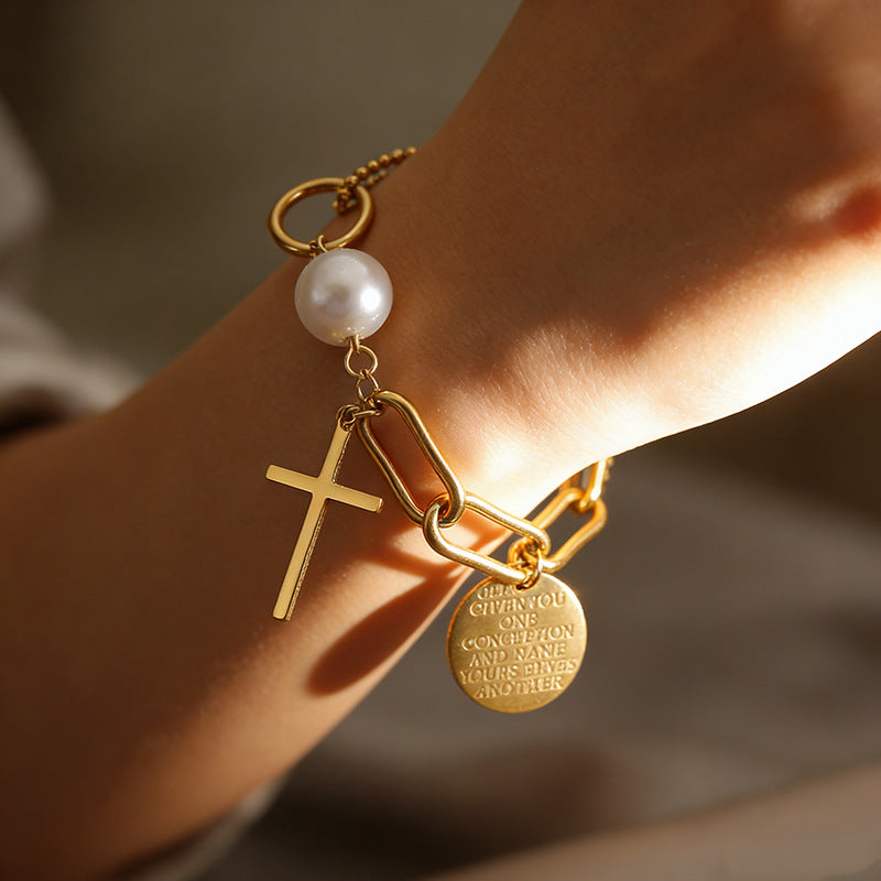 Cross charm pearl bead and engraved quote disc paperclip chain stainless steel jewelry bracelet in waterproof 18k gold plated finish.