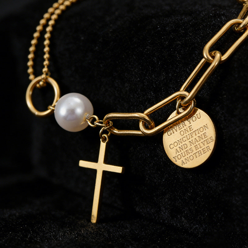 Cross charm pearl bead and engraved quote disc paperclip chain stainless steel jewelry bracelet in waterproof 18k gold plated finish.