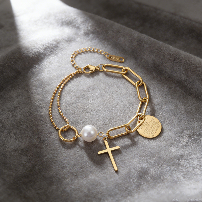 Cross charm pearl bead and engraved quote disc paperclip chain stainless steel jewelry bracelet in waterproof 18k gold plated finish.
