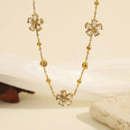 Cubic zirconia cz crystal flower stations and bezel round gems gold bead link chain necklace stainless steel jewelry in waterproof 18k gold plated finish.