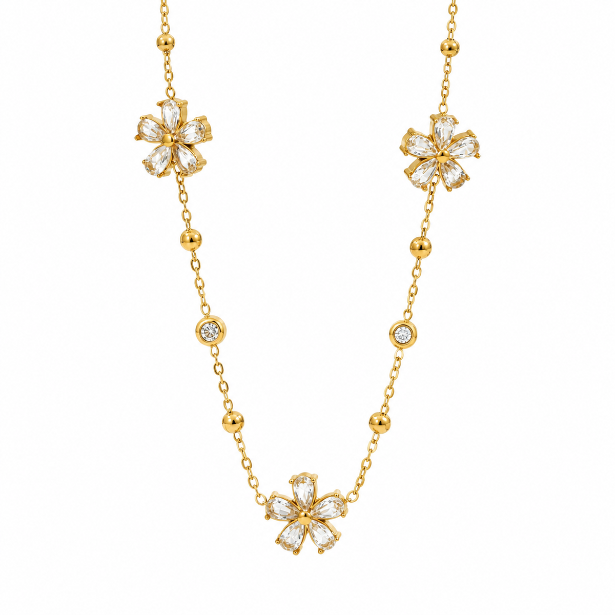 Cubic zirconia cz crystal flower stations and gold bead accents link chain bracelet stainless steel jewelry in waterproof 18k gold plated finish.