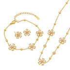 Cubic zirconia cz crystal flower stations and gold bead accents necklace bracelet stud earrings stainless steel jewelry set in waterproof 18k gold plated finish.