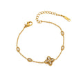 Cubic zirconia cz four petal flower pendant and oval bezel stations cable chain stainless steel jewelry bracelet in waterproof 18k gold plated finish.