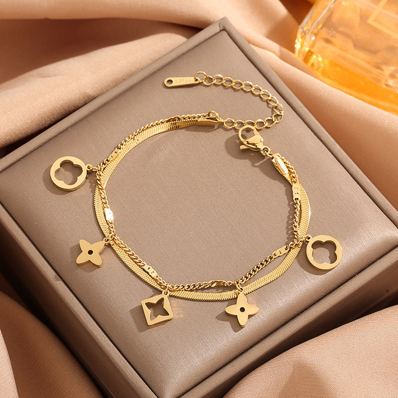 Double layer flat snake chain and cable link with clover motifs and geometric charms stainless steel jewelry bracelet in waterproof 18k gold plated finish.