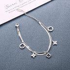 Double layer flat snake chain and cable link with clover motifs and geometric charms stainless steel jewelry bracelet in waterproof 18k gold plated finish.