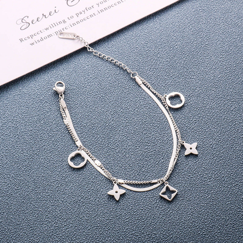 Double layer flat snake chain and cable link with clover motifs and geometric charms stainless steel jewelry bracelet in waterproof 18k gold plated finish.