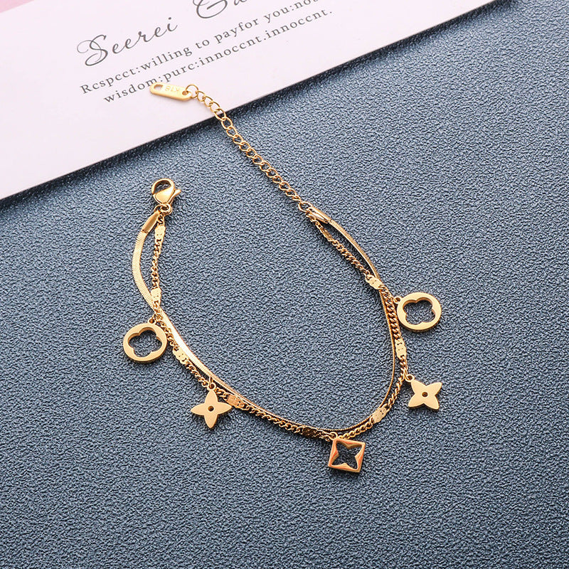 Double layer flat snake chain and cable link with clover motifs and geometric charms stainless steel jewelry bracelet in waterproof 18k gold plated finish.
