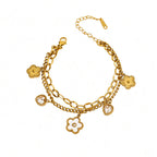Double layer link chain white shell flower motif and heart cubic zirconia charm stainless steel jewelry bracelet in waterproof 18k gold plated finish.