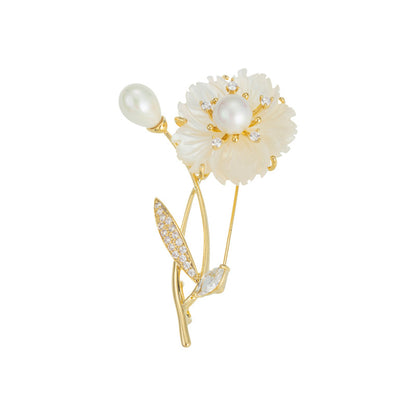 Elegant floral bouquet brooch featuring white cubic zirconia petals and a central pearl in a gold setting